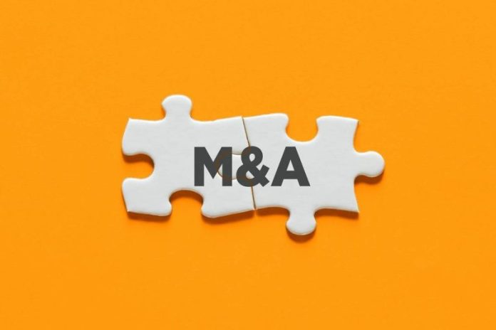 <strong>South African gold producer Pan African Resources (LSE:PAF) has agreed to acquire Australian explorer Emmerson (LSE:EML) in an all-share transaction valued at approximately US$218 million.</strong>
The acquisition will be carried out through a scheme of arrangement under which Pan African will acquire 100 percent of Emmerson’s issued share capital.
Under the terms of the deal, Emmerson shareholders will receive 0.1493 Pan African shares in the form of ASX-listed Chess Depositary Interests for each Emmerson share held. Following completion of the transaction, Emmerson shareholders will own about 4.24 percent of the combined company.
The deal consolidates ownership of the Tennant Creek joint venture, where Pan African is currently partnered with Emmerson to explore and develop gold deposits across a large tenement package in Australia’s Northern Territory.
“This combination with our trusted JV partner represents a strategically logical consolidation of our Tennant Creek tenement package,” Emmerson chair Mark Connelly said in a company press release.
Tennant Creek, located between Alice Springs and Darwin, is one of Australia’s historic gold districts, known for high-grade deposits discovered during a mining boom in the 1930s.
Pan African chief executive Cobus Loots said the acquisition would allow the company to streamline development plans for new discoveries in the district, including the White Devil gold deposit.
The company currently operates a mix of low-cost surface operations and high-grade underground mines across South Africa and Australia. It is forecast to produce more than 275,000 ounces of gold in the 2026 financial year.
Pan African’s resource base totals approximately 42.9 million ounces of mineral resources and 13 million ounces of ore reserves, providing a long-term pipeline for production growth.
Loots said diversification is essential in the mining industry, where individual assets inevitably decline over time.
“In mining you are exploiting a wasting asset – so you’re either moving backwards or you’re progressing,” Loots told Currency in a recent interview. “We don’t want to move backwards.”
The transaction remains subject to several conditions, including shareholder approval and customary regulatory clearances.
A shareholder vote is expected to take place in mid-2026, with completion anticipated shortly thereafter if the scheme is approved.
<strong>Securities Disclosure: I, Giann Liguid, hold no direct investment interest in any company mentioned in this article.</strong>
This post appeared first on investingnews.com